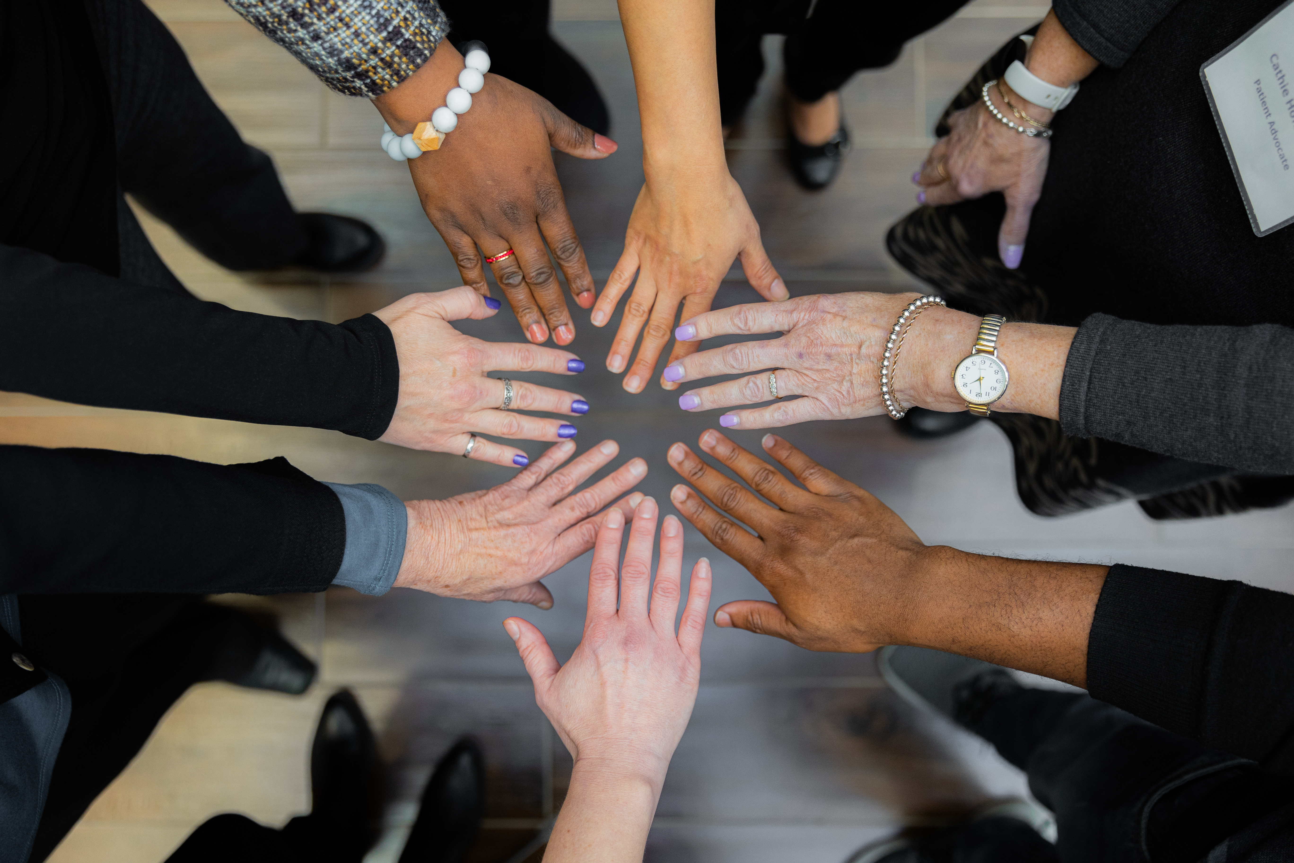 huddle of multiple hands